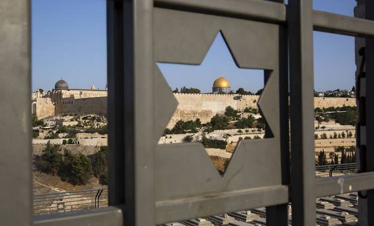 Jerusalem’s Old City is seen through a door with the shape of star of David. (AP Photo)